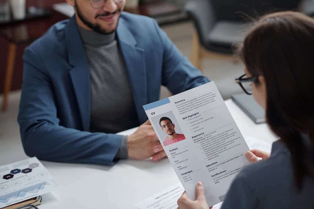 Hiring manager reading a candidate's verified microcredential during the physical interview